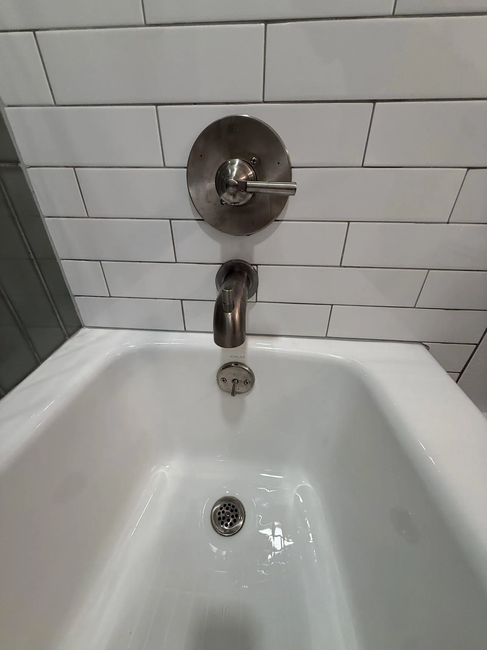 Close-up of a bathroom faucet with water spots on the metal finish