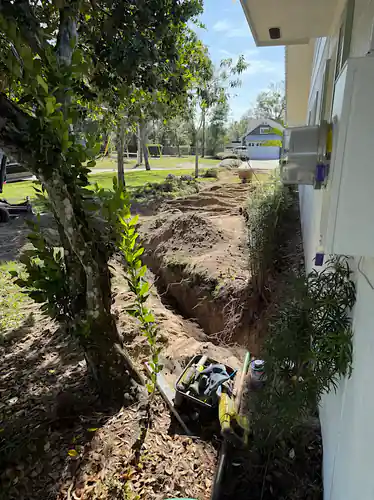 Side yard trench for a new sewer line at a Windermere home
