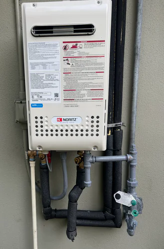Noritz tankless gas water heater mounted and connected in a Winter Garden home