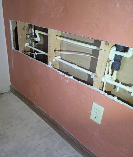 New CPVC repipe lines run through an open wall on a Winter Garden home