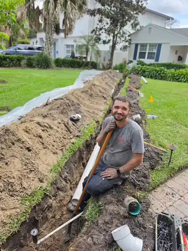 Herrell plumber working in an open sewer trench at a Windermere property